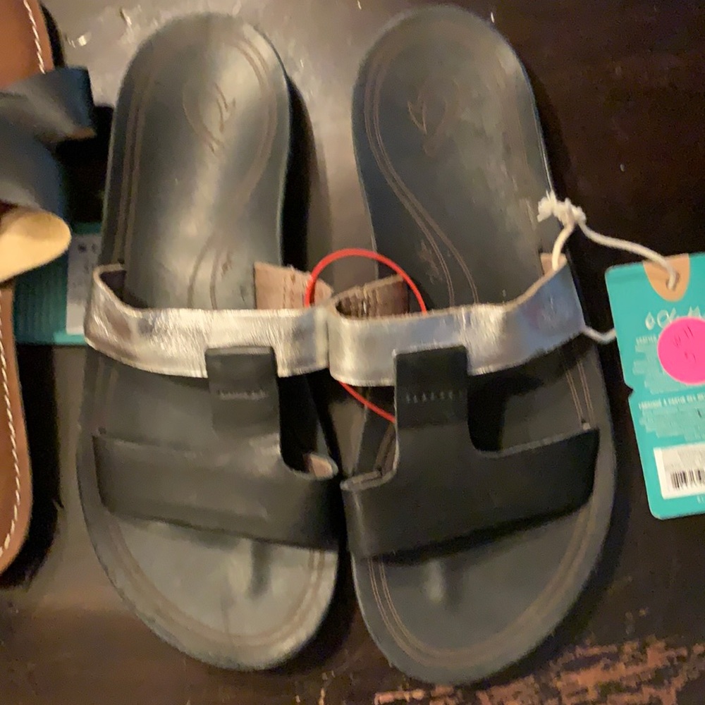Brand new OluKai sandals. Black and Silver